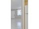A living room featuring neutral tile floors and view into the kitchen at 1012 Pearce Dr # 105, Clearwater, FL 33764