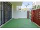 Private patio with gate and brick accents overlooking lush landscaping at 1012 Pearce Dr # 105, Clearwater, FL 33764