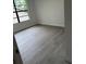 Cozy bedroom with modern gray flooring and a large window for natural light at 10216 N Pawnee Ave, Tampa, FL 33617