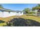 Spacious backyard featuring a manicured lawn, privacy fence, and a sunny atmosphere at 10900 Oakdale Ave, Port Richey, FL 34668