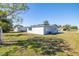 Expansive backyard with lush green grass and partial fencing, offering ample space at 10900 Oakdale Ave, Port Richey, FL 34668