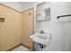 This bathroom features classic tile, a functional sink, and a mirrored medicine cabinet at 10900 Oakdale Ave, Port Richey, FL 34668