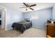 Comfortable bedroom features one window, tile flooring, and a ceiling fan at 10900 Oakdale Ave, Port Richey, FL 34668