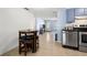 Functional kitchen area with stainless steel appliances and easy access to the living room at 10900 Oakdale Ave, Port Richey, FL 34668