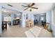 Open-concept living space with tile flooring, and views into the kitchen, dining area, and office at 10900 Oakdale Ave, Port Richey, FL 34668