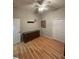 Bedroom with wood-look floors, ceiling fan and dresser at 12450 Eclipse Ct, New Port Richey, FL 34654