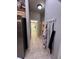 Hallway includes a door into the laundry room, a coat rack, and access to the bathroom at 12450 Eclipse Ct, New Port Richey, FL 34654