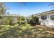 A view of the backyard and exterior of this single Gathering home with new solar panels at 1407 Overlea St, Clearwater, FL 33755
