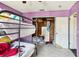 A bedroom featuring a bunkbed, purple walls, and a cluttered closet at 1407 Overlea St, Clearwater, FL 33755