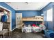 Blue bedroom featuring a bunk bed, closet, and a window, providing a cozy space at 1407 Overlea St, Clearwater, FL 33755