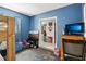 This bedroom features blue walls, a bunk bed, and a doorway leading to another room at 1407 Overlea St, Clearwater, FL 33755