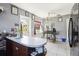 Kitchen featuring a peninsula counter, white tile floors, and natural light at 1407 Overlea St, Clearwater, FL 33755