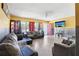 Spacious living room with a view of the pink front door and modern entertainment setup at 1407 Overlea St, Clearwater, FL 33755