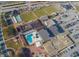 An aerial view of the community center with a pool, bocce ball, lawn bowling, shuffleboard, and parking at 1507 Hartwick Dr, Sun City Center, FL 33573