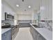 Bright kitchen featuring stainless steel appliances, gray cabinetry, and decorative backsplash at 1507 Hartwick Dr, Sun City Center, FL 33573