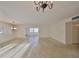 Large living room with chandeliers and view into open floor plan at 1507 Hartwick Dr, Sun City Center, FL 33573