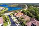 Aerial view of a lovely home near the lake with a beautiful red roof at 16106 Amethyst Key Dr, Wimauma, FL 33598