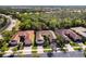 Aerial view of a single Gathering home with lush trees in a well kept neighborhood at 16106 Amethyst Key Dr, Wimauma, FL 33598