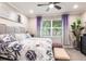 Bedroom features neutral paint, carpet, king bed, and large window with a plant at 16106 Amethyst Key Dr, Wimauma, FL 33598