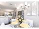 Bright breakfast nook with a glass top table, white chairs, and stainless steel appliances in the background at 16106 Amethyst Key Dr, Wimauma, FL 33598