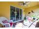 Comfortable lanai seating area features red and white cushions and sliding glass doors at 16106 Amethyst Key Dr, Wimauma, FL 33598