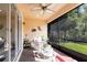 Cozy lanai with outdoor seating, a ceiling fan, and a view of lush greenery at 16106 Amethyst Key Dr, Wimauma, FL 33598