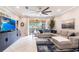 Bright living room with a large sectional couch, stylish decor, and outdoor views at 16106 Amethyst Key Dr, Wimauma, FL 33598