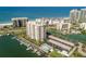 An aerial view of the condo building, its amenities, the marina and beach at 1621 Gulf Blvd # 308, Clearwater Beach, FL 33767