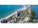 A scenic aerial view of beachfront condos, white sand, and stunning water views at 1621 Gulf Blvd # 308, Clearwater Beach, FL 33767