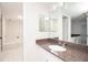 Bathroom with granite counters, white cabinets and tile floor at 1621 Gulf Blvd # 308, Clearwater Beach, FL 33767