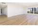 Bright living room with hardwood floors and a large window showcasing city views at 1621 Gulf Blvd # 308, Clearwater Beach, FL 33767