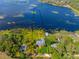 Aerial view of the property highlighting lakefront access and lush surroundings at 18253 Townsend House Rd, Dade City, FL 33523