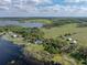 Scenic aerial view of a home near a lake at 18253 Townsend House Rd, Dade City, FL 33523