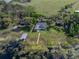 Aerial top down perspective shows swimming pool, boat dock and sheds at 18253 Townsend House Rd, Dade City, FL 33523