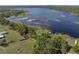 Aerial view of a lakefront property with lush greenery at 18253 Townsend House Rd, Dade City, FL 33523