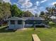 The backyard shows a screen enclosed pool and private yard with a dock at 18253 Townsend House Rd, Dade City, FL 33523