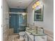 Well-lit bathroom featuring a glass-enclosed shower and unique glass vessel sink at 18253 Townsend House Rd, Dade City, FL 33523