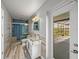 Modern bathroom with glass shower, stylish vanity, and access to an outdoor patio at 18253 Townsend House Rd, Dade City, FL 33523