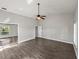 Spacious bedroom with wood-look floors, vaulted ceilings, and a ceiling fan at 18253 Townsend House Rd, Dade City, FL 33523