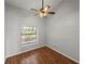 Bedroom with hardwood floor, a window, and a ceiling fan at 18253 Townsend House Rd, Dade City, FL 33523