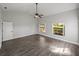 Bright bedroom with hardwood floors, vaulted ceiling, and large windows overlooking the yard at 18253 Townsend House Rd, Dade City, FL 33523