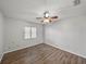 Simple bedroom featuring wood-look floors, neutral walls and a ceiling fan at 18253 Townsend House Rd, Dade City, FL 33523