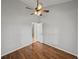 Bedroom with hardwood flooring, ceiling fan and access to other rooms at 18253 Townsend House Rd, Dade City, FL 33523