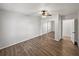 Bedroom featuring wood-look floors, sliding mirrored closet doors, and neutral paint at 18253 Townsend House Rd, Dade City, FL 33523