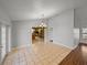 Open-concept dining area featuring tile floors, decorative light fixture and views of the kitchen at 18253 Townsend House Rd, Dade City, FL 33523