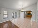 Open-concept dining area featuring tile floors, decorative light fixture and views of the kitchen at 18253 Townsend House Rd, Dade City, FL 33523