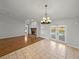 Open-concept dining area featuring tile floors, views of the fireplace, screened-in lanai and pool at 18253 Townsend House Rd, Dade City, FL 33523
