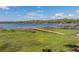 A new wooden dock with seating on the waterfront provides a relaxing spot to enjoy lake views at 18253 Townsend House Rd, Dade City, FL 33523