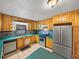 Kitchen with stainless steel appliances, tile floors, and wood cabinets at 18253 Townsend House Rd, Dade City, FL 33523