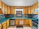 Open kitchen featuring a sink beneath a large window and wood cabinets at 18253 Townsend House Rd, Dade City, FL 33523